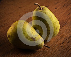 Two green pears on wooden crate