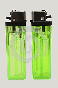 two green plastic lighter or cigarette lighter isolated on white background.