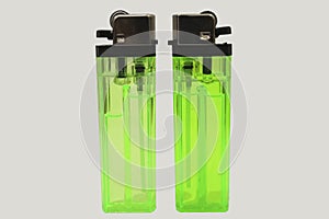 two green plastic lighter on white background.