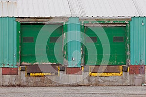 Two green shuttered outside loading gate ramps photo