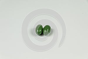 Two green soft gelatine capsules.