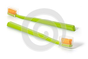 Two green toothbrushes on a white background. Full depth of field.