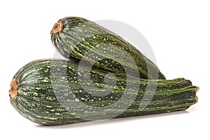 Two green zucchini isolated on white background