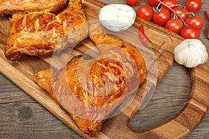 Two Grilled BBQ Chicken Leg Quarter On Wood Board