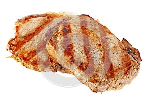 Two grilled pork chops on white background