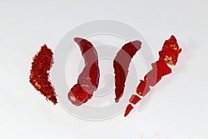 two ground peppers one paprika and one chopped paprika on a white background creatively