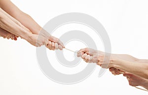 Two group of people pulling a cord