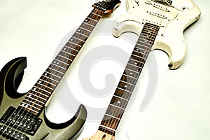 Two guitar, neck fretboard on a white background.Black, white, brown.