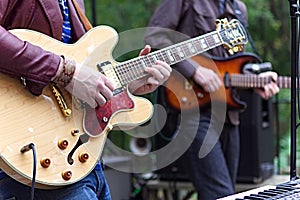 Two guitarists playing outside during the day