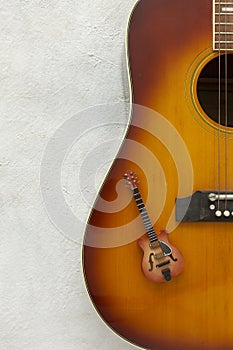 Two guitars big and small on a white background