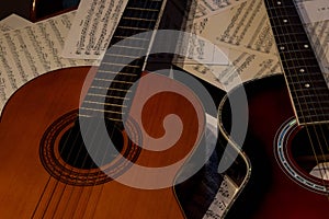 Two guitars one acoustic and another spanish.