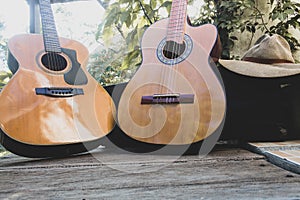 two guitars on wood with nature background, vintage photo