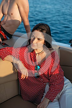 Two guys and one attractive girl on yacht. Weekend party at sea.