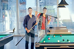 Two guys in pool billiard club playing pool billiard