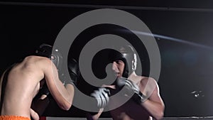 Two guys preparing for kickboxing competitions. Slow motion. Silhouette