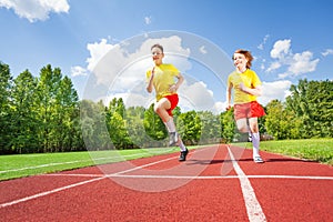 Two guys running together in competition photo