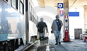 Two guys are searching for their train.