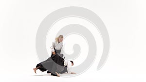Two guys showing aikido using tanto. Isolated, white. Close up.