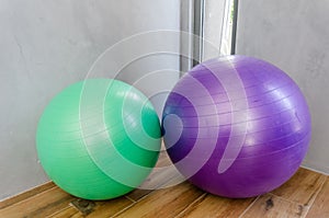 two gym balls are next to each other on the floor
