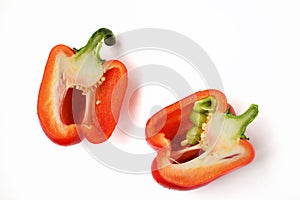Two half of a bright red raw washed with green tail bulgarian sweet pepper isolated on white background