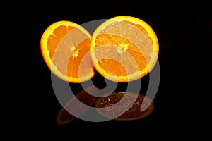 Two  half orange isolated on black with reflections