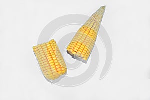 Two half pieces of sweet yellow ear of corn isolated in a white background