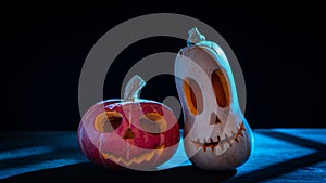 Two Halloween pumpkins in the moonlight