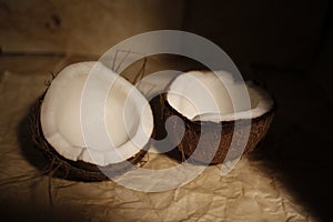 Two halves of coconut with white pulp