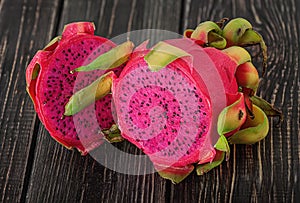 Two halves of dragon fruit on planks