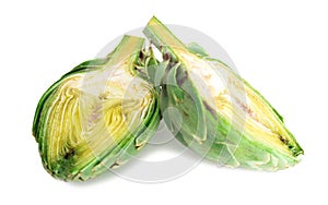 Two halves of ripe green artichokes on a white background