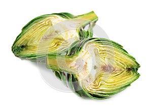 Two halves of ripe green artichokes on a white background