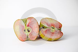 Two halves of a single lucy glo apple on a white background