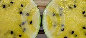 two halves of a sliced yellow watermelon