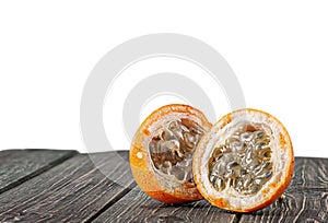 Two halves of tamarillo on wooden table