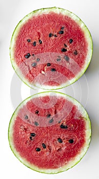 Two halves of watermelon on a white background. Ripe waterbeuse with seeds. Summer berry - red watermelon.
