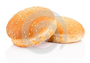 Two hamburger buns with sesame on white background