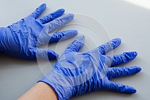 Two hand in blue latex glove, personal protective equipment medical accessory to ensure the safety of staff and patient. To