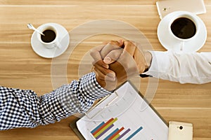 Two hand businessman partner or business rivals clash arm wrestle on table in cafÃÂ©.Concept business competition photo
