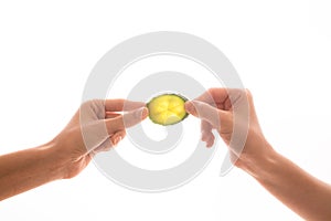 Two hand holding the slice of cucumber on white background