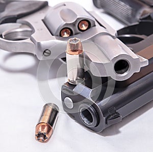 Two handguns, a 40 caliber pistol and a 357 magnum revolver on a white background