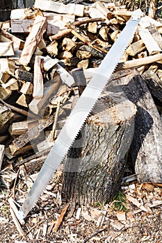 Two-handled saw and ax in chopping deck