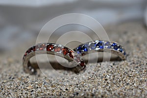 Two handmade blue and red wedding rings