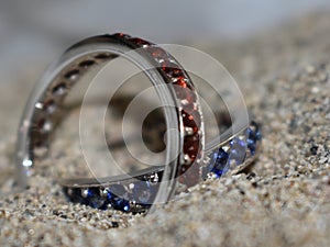 Two handmade blue and red wedding rings