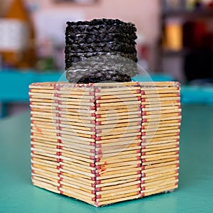 Two handmade cubes on a blurred background