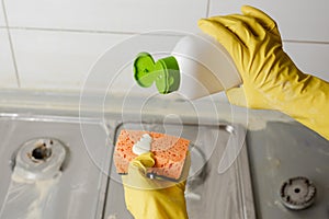 Extruding the detergent onto the sponge, close-up photo