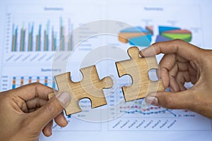 Two hands of businessman to connect couple puzzle piece. symbol of association and connection. business strategy