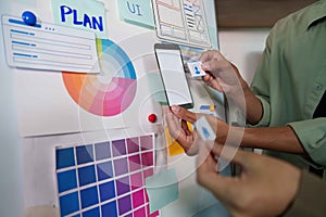 Teamwork in UI Design. Hands placing elements on a planning board.