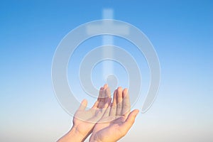 Two hands and cross of christ and believers