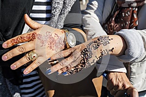 Two hands decorated with floral henna design