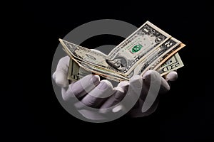 two hands with dollars. Closeup female hand giving money for something with isolated on black background,count, paying, shopping